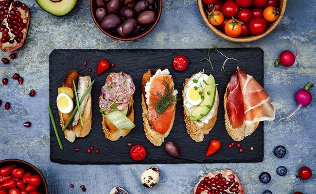 Several toast with ham, eggs, salmon or avocado